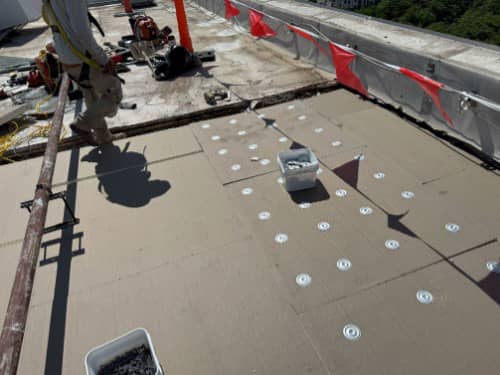 New insulation being installed over the replaced decking areas that were damaged by rusting. 