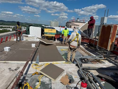 Overview of insulation installation over new decking. This daylight photo corresponds to the infrared imagery shown in this case study. 