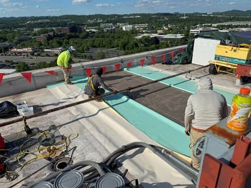 New membrane being installed over new insulation and decking. 