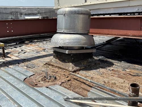 Working in details for installing new deck around penetrations. 