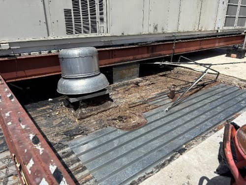 Working in details for installing new deck around penetrations. 