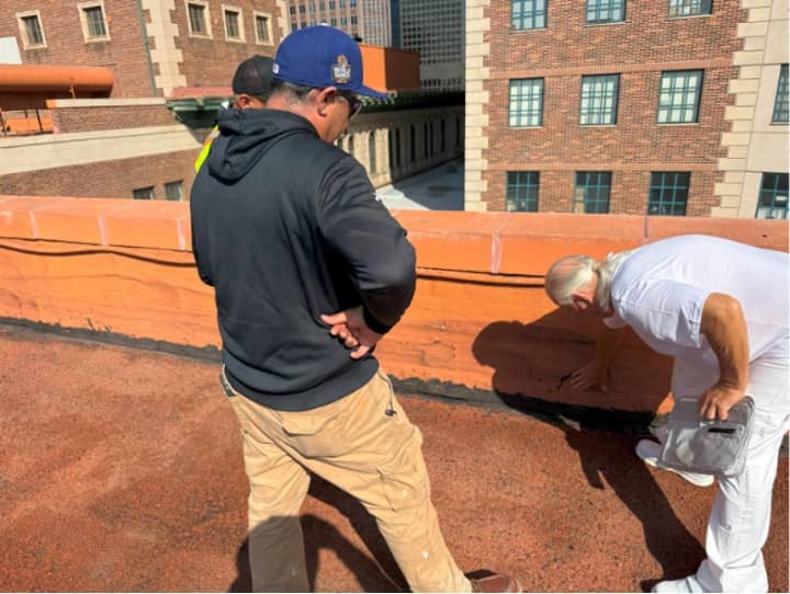 Instructing crew on how to apply 1047 to base flashings