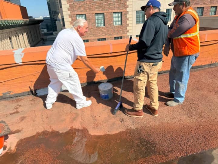 Instructing crew on how to apply 1047 to base flashings