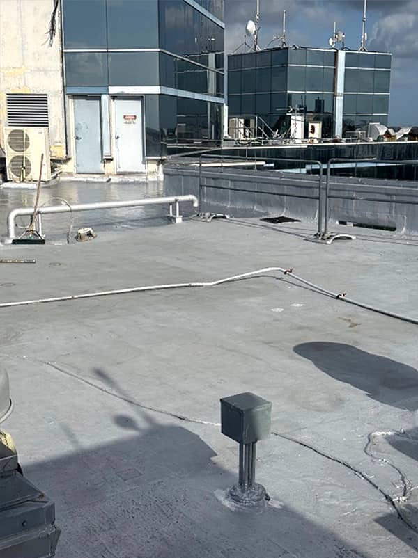 Second coat of liquid membrane in background